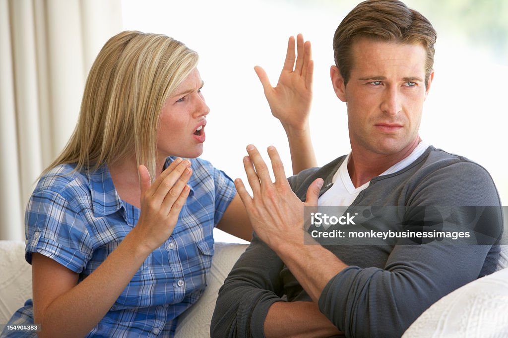 Young Couple Having Argument At Home  Arguing Stock Photo