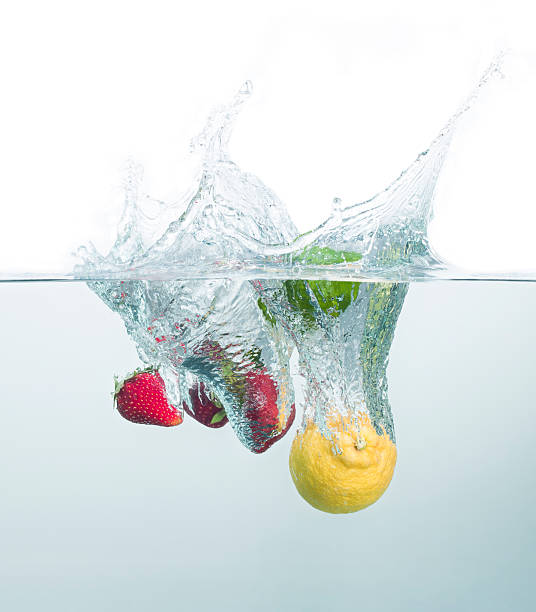 istock Strawberries and lemons cocktail splashing into the water 154904451