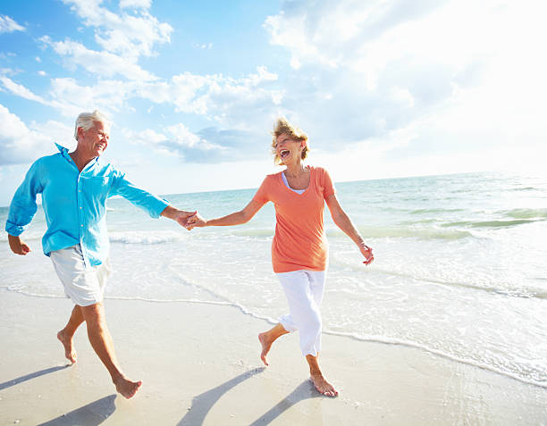 istock Retired couple laughing on the beach 154904835