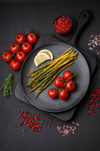Delicious nutritious breakfast consisting of asparagus, tomatoes, salt, spices and herbs