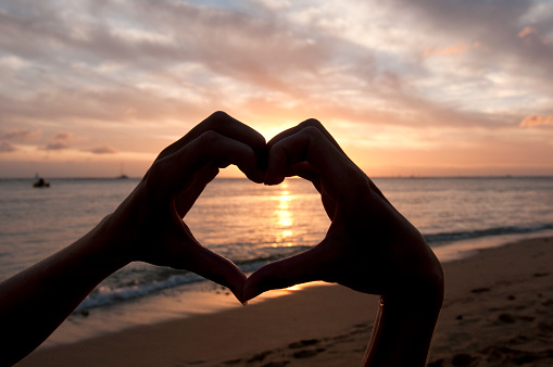 Heart shape hands at Sunset.