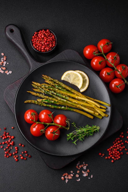 Delicious nutritious breakfast consisting of asparagus, tomatoes, salt, spices and herbs