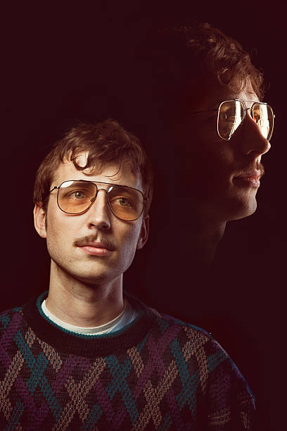 Emulated Vintage Portrait Photograph A man from the 1980s with glasses and a mustache poses for a picture.  Intentional 80's style kitsch post processing emulation.  Vertical. high school photos stock pictures, royalty-free photos & images