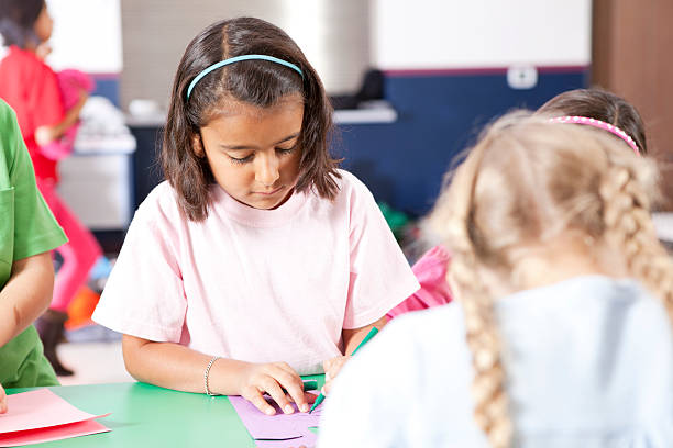 istock Group of elementary age children busy with arts project 154906553