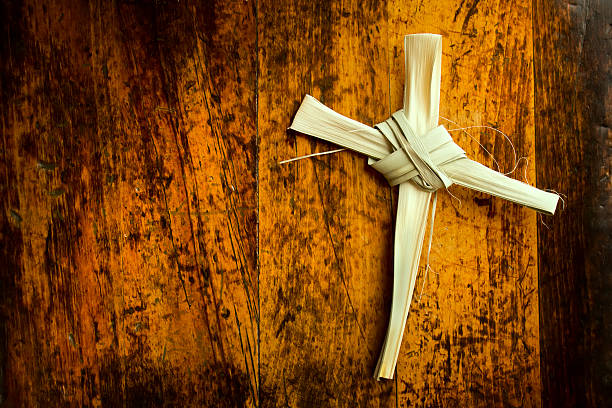 Easter Cross Made From Palm Sunday Branch on Wooden Bench stock photo