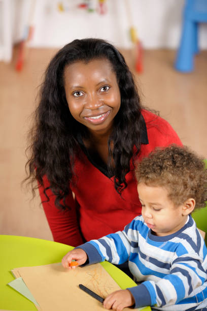 istock Biracial Toddler Doing Artwork While Carer Supervises 154906897
