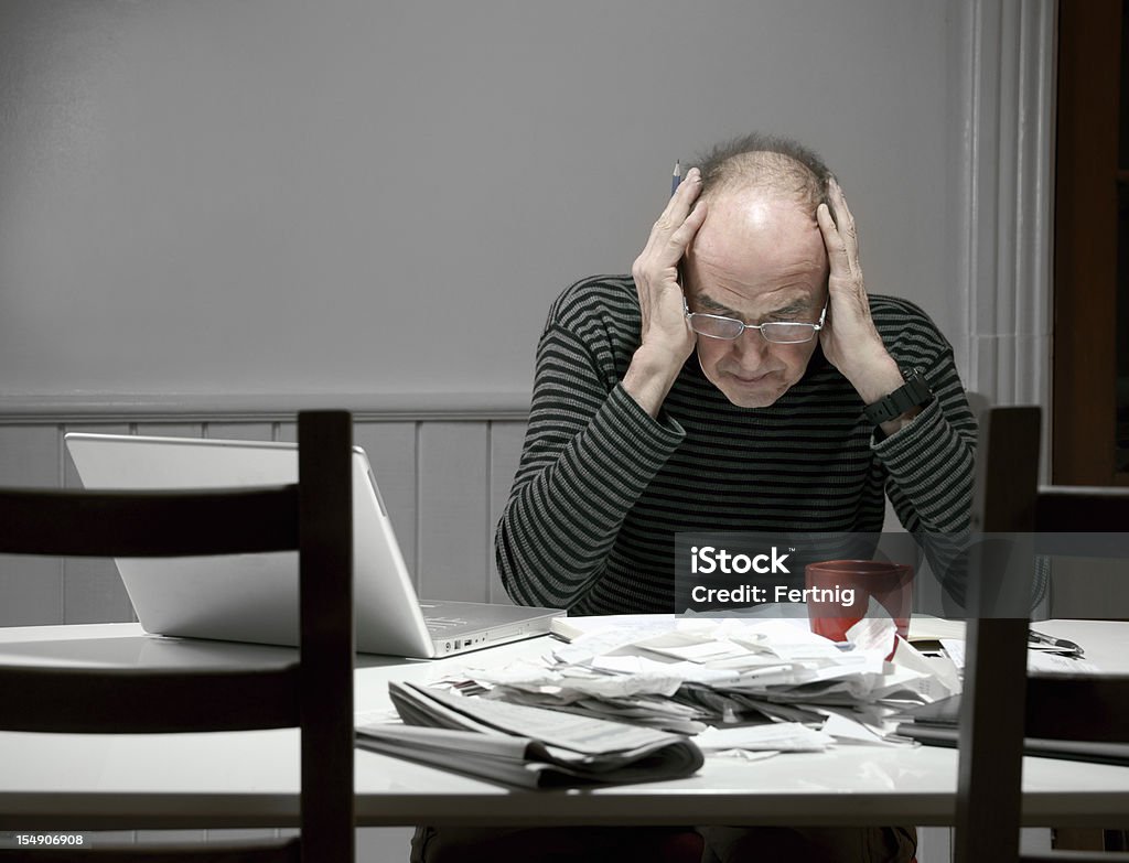 Mature man stressed out by tax preparation  Emotional Stress Stock Photo