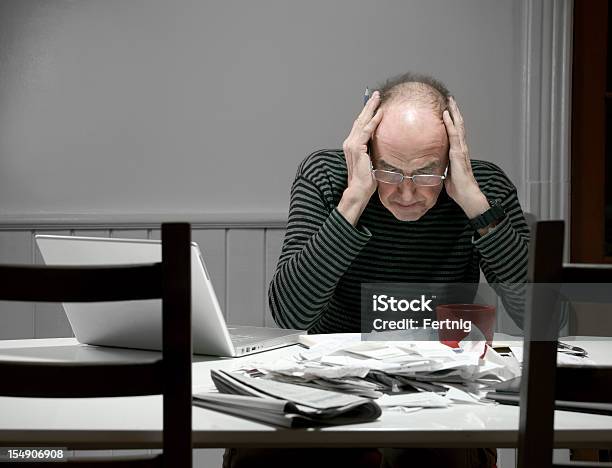 Mature Man Stressed Out By Tax Preparation Stock Photo - Download Image Now - Emotional Stress, Financial Bill, Senior Adult