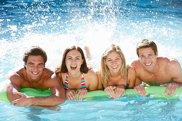 istock Group of four smiling adults on a single pool noodle 154907089