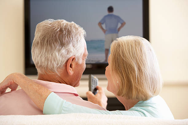 istock Senior Couple Watching Widescreen TV At Home 154907113