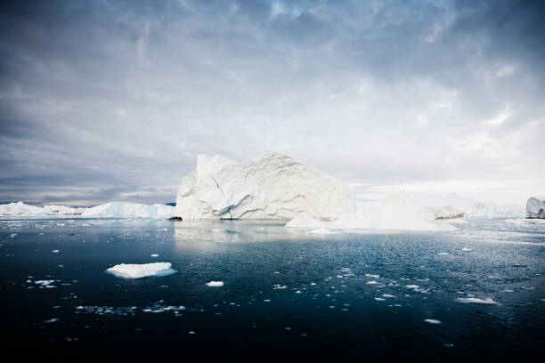 Blue iceberg reflected in the calm waters of Crystal Sound, Antarctic Peninsula