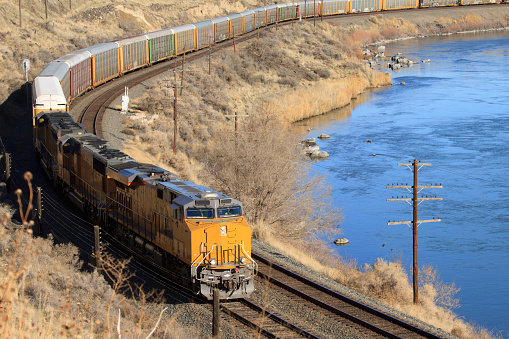 Freight train rounding the bend on the Snake River near Glenns Ferry, Idaho.