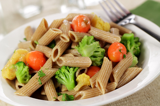 Lunch consisting of whole wheat pasta and vegetables
