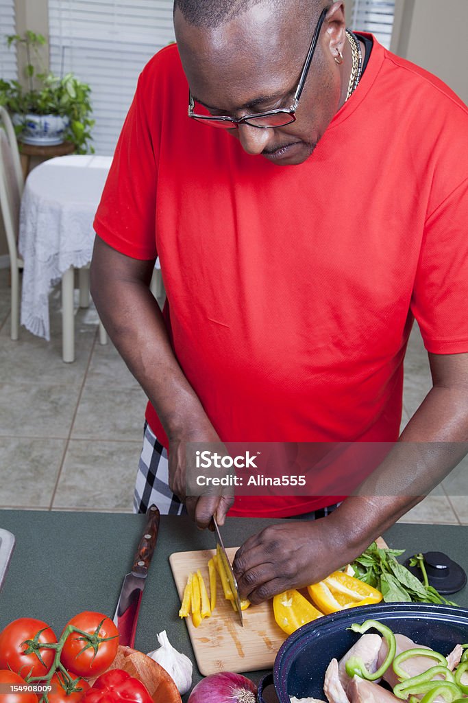 African american man cooking in the home kitchen African american man cooking in the home kitchen.  You might also be interested in this: 40-49 Years Stock Photo