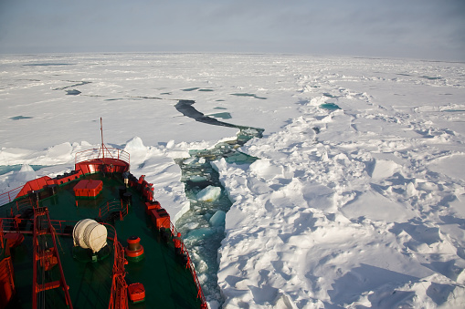 Arctic ocean with pack ice in front of a russian nuclear icebreaker. Symbolic for climate changes and global warming. Russian arctic north of Franz Josef Land on the way to the North Pole.