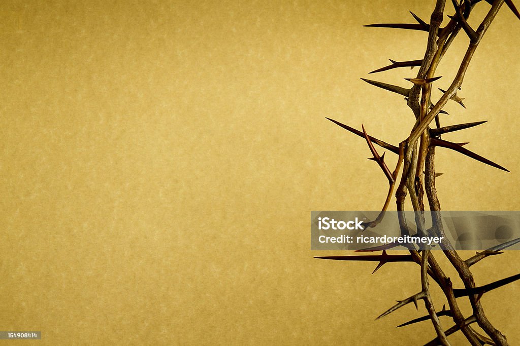 Crown Of Thorns Represents Jesus Crucifixion on Good Friday This Crown of Thorns against parchment paper represents Jesus Christ's Crucifixion on the Cross on Good Friday During Holy Week. Jesus Christ Stock Photo