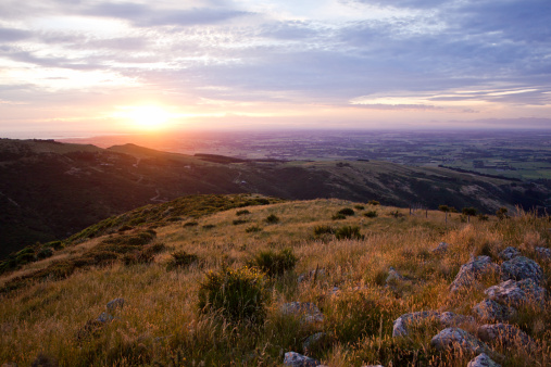 Sunset from the Port hills over the Canterbury Plains and Christchurch. Banks Peninsula, South Island, New Zealand.