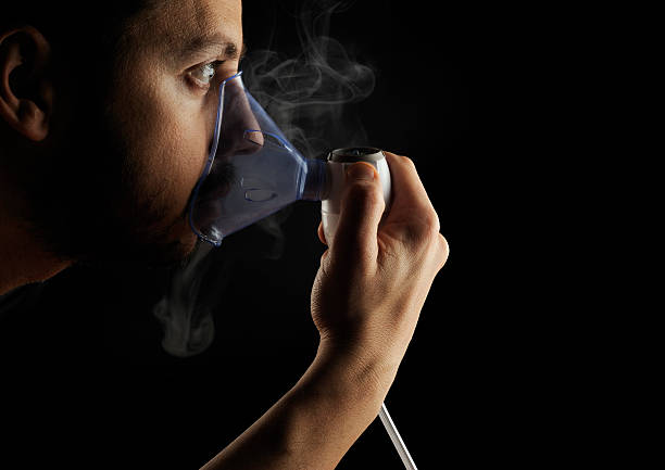 Inhalation therapy profile on black background stock photo