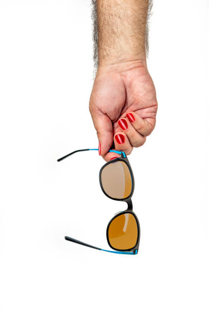 istock Male hand with red fingernails hold sunglasses 1549093200