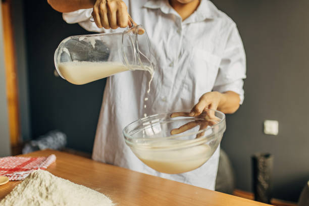 istock A woman pours milk into a glass container 1549124130