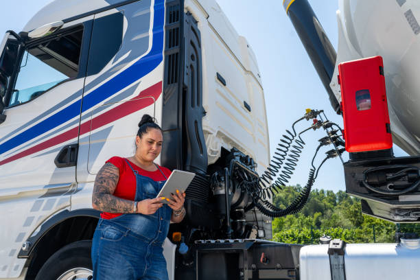 istock Side view of a heavy female cistern driver looking at tablet 1549127729