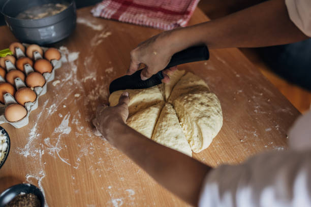 istock Woman cutting dough into pices 1549169472