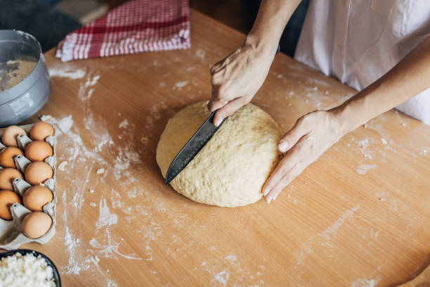istock Woman cutting dough into pices 1549171003