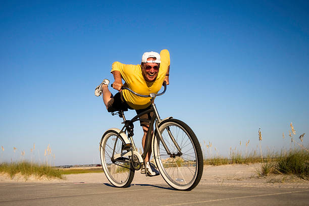 Color image depicting the blurred motion of a man riding his mountain bike on a rural forest path. The long exposure emphasises the speed of the bike.