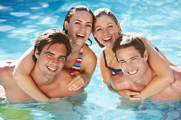 istock Group Of Friends Having Fun In Swimming Pool 154917666