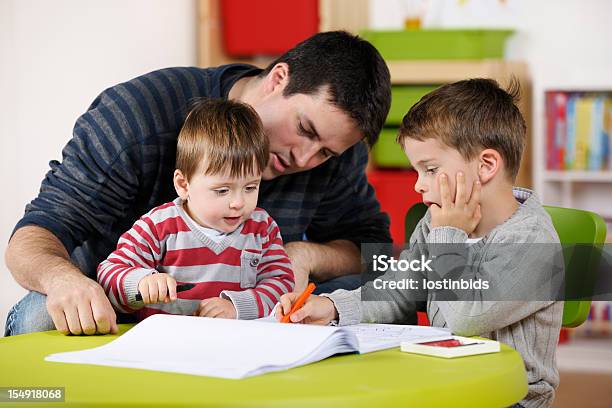 Father Enjoying Time With His Sons Stock Photo - Download Image Now - Males, Teacher, 12-17 Months