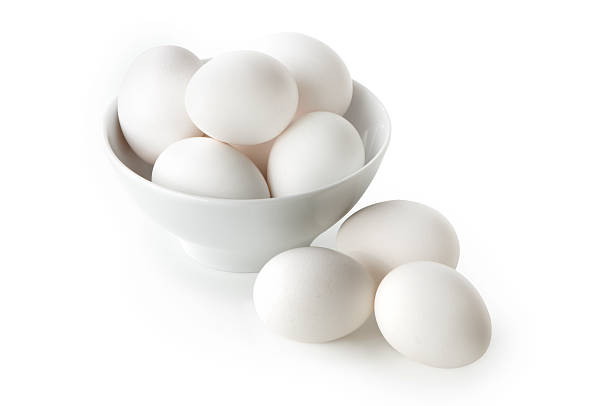 White eggs on white bowl against white background stock photo