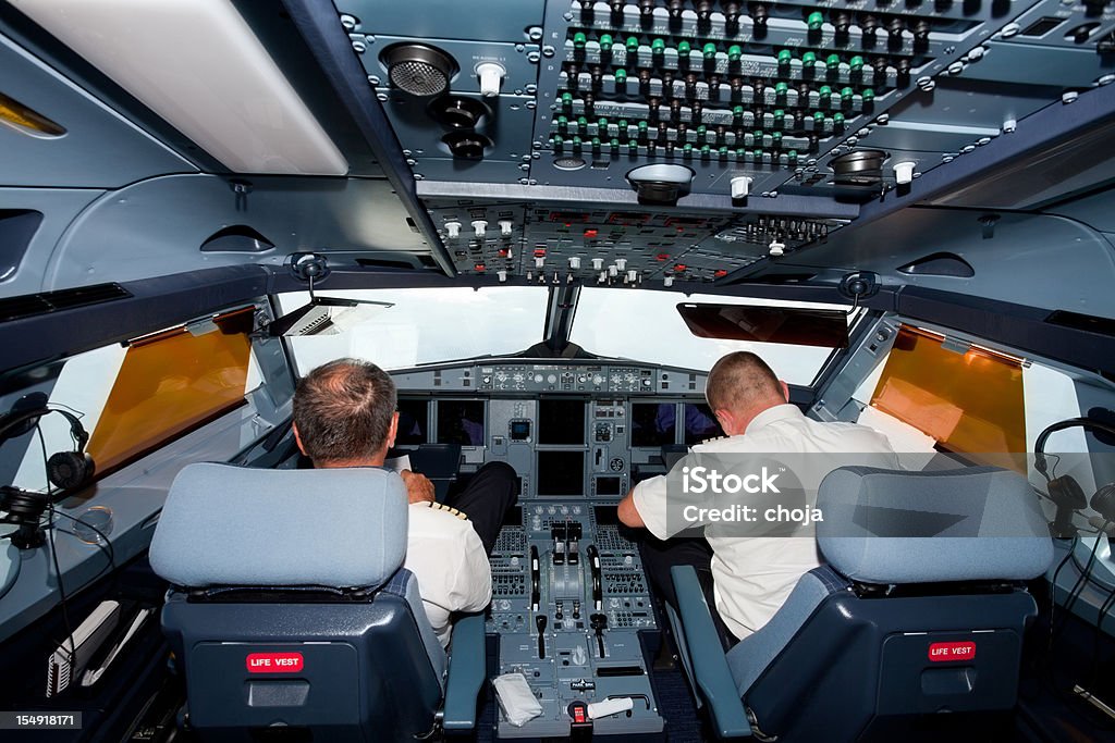 Pilots in the cockpit of commercial airplane Air Vehicle Stock Photo
