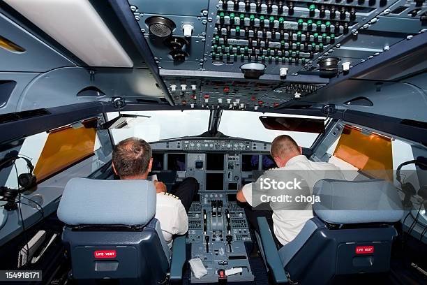 Pilots In The Cockpit Of Commercial Airplane Stock Photo - Download Image Now - Air Vehicle, Airplane, Co-Pilot