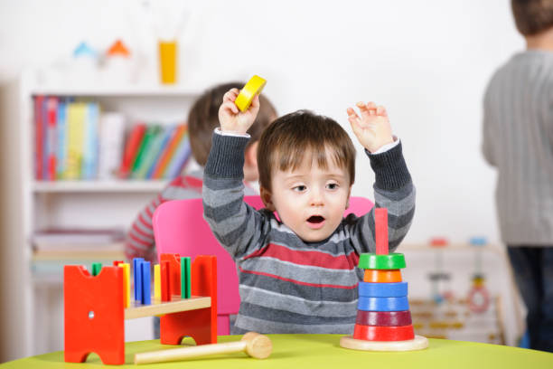 istock Toddler Arms Raised Showing Excitement While Playing With Rings 154918611