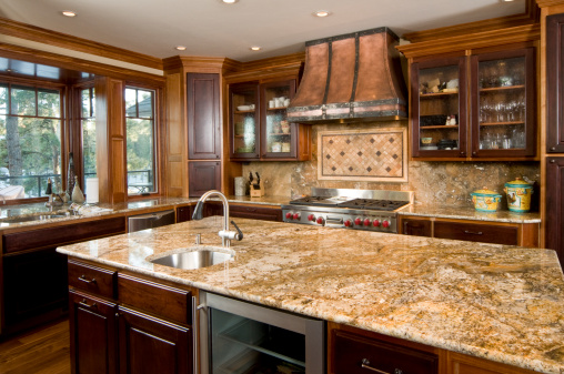This modern kitchen has a granite counter island.