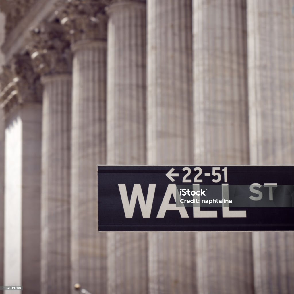 Wall street sign and columns Wall street sign and defocused classic columns on the back. New York Stock Exchange Stock Photo