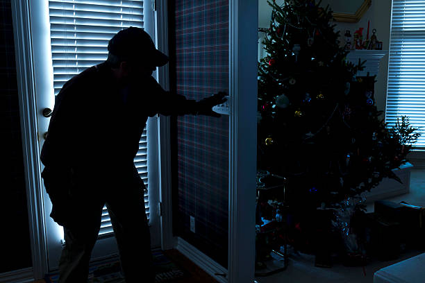 Intruder breaking in at Christmas while the family is away stock photo