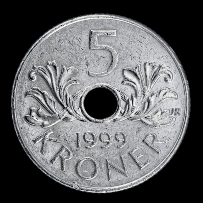 Macro close-up of a used Norwegian five Kroner coin issued in 1999, isolated on white.