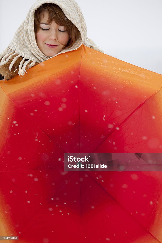 Girl: listening the silence Girl: under snowing with shawl and orange umbrella at Christmas Adult Stock Photo