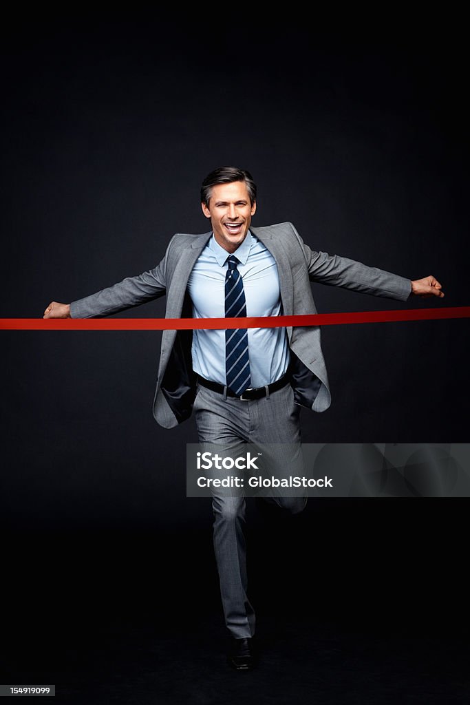 Executive reaching goal Full length businessman crossing finish line 30-39 Years Stock Photo