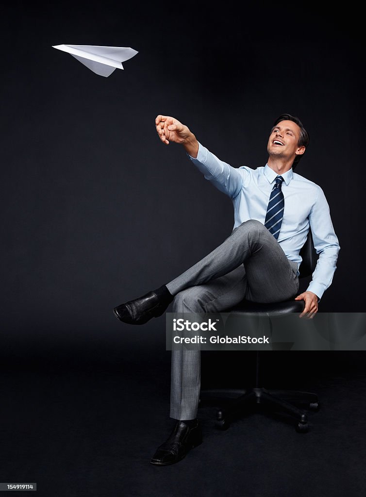 Aburrido executive tirando avión de papel - Foto de stock de Lanzar - Actividad física libre de derechos