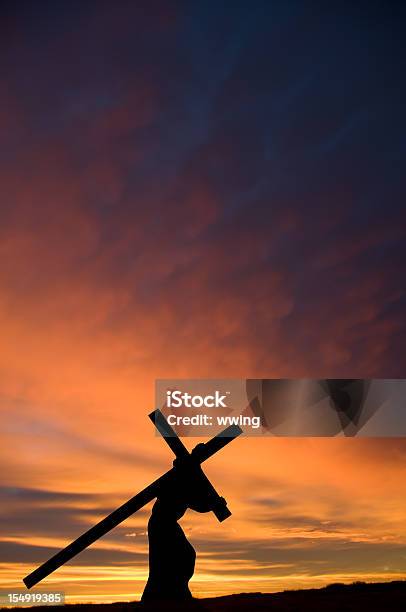 Jesus Carrying The Cross With Orange Sunset Vertical Stock Photo - Download Image Now