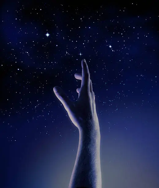 male hand reaching for the stars