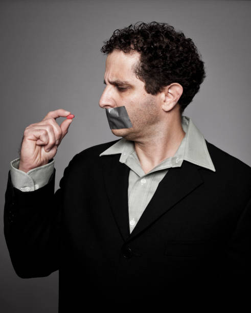 istock Man with duct tape looking at pill 154919668