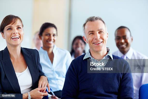 Executives Smiling While Listening Presentation Stock Photo - Download Image Now - 40-49 Years, 50-59 Years, Administrator