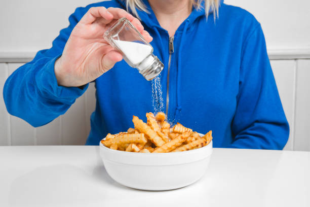 Salt on french fries Putting salt on french fries sodium intake stock pictures, royalty-free photos & images