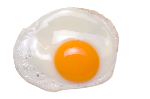 A fried egg, isolated on white.
