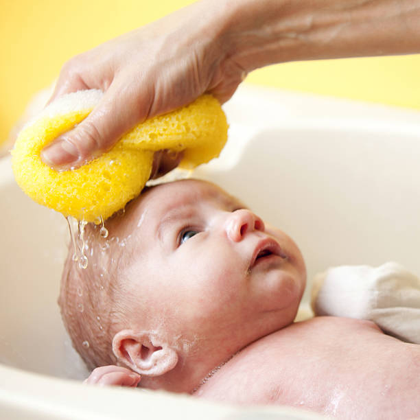 Newborn bathing stock photo