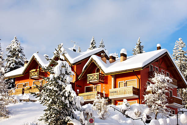typical wooden facade with flower boxes in the swiss valais canton in the Binntal area with mountains in the background
