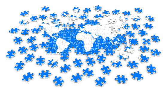 Semi-attached puzzle with painted blue world map isolated on white background.